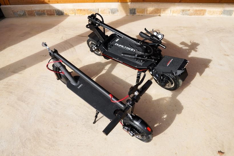 Dualtron Storm Folded Against Commuter Scooter